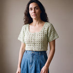 Ivory hand-crocheted organic cotton cropped top in sage, worn buttoned with five pearl buttons - Ana Chic