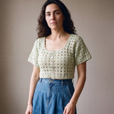 Ivory hand-crocheted organic cotton cropped top in sage, worn buttoned with five pearl buttons - Ana Chic