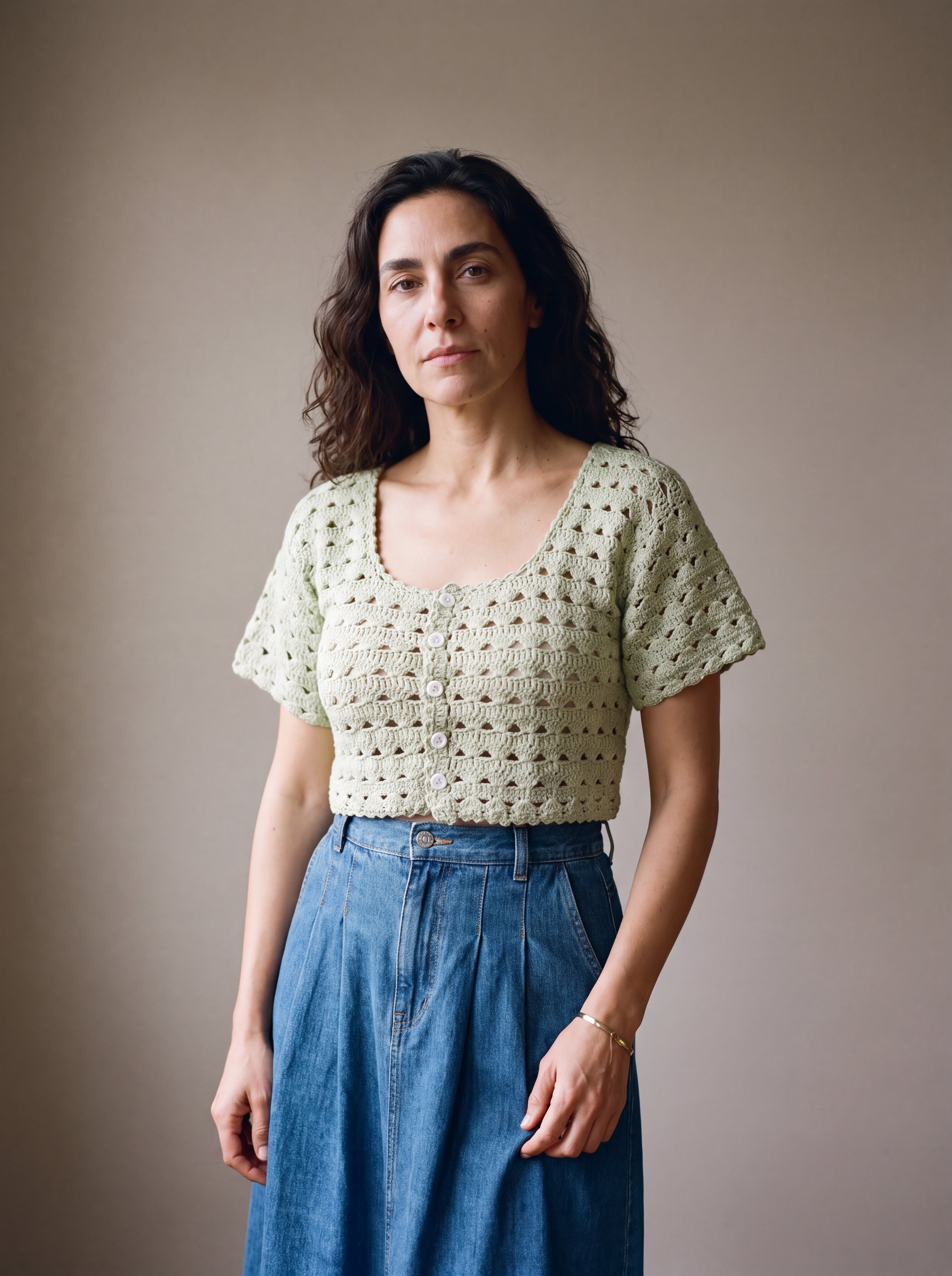 Ivory hand-crocheted organic cotton cropped top in sage, worn buttoned with five pearl buttons - Ana Chic