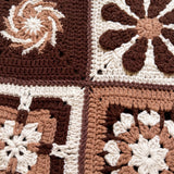 Close-up of four different hand-crocheted squares on the Sampler Cardigan in Brown, each a different motif design