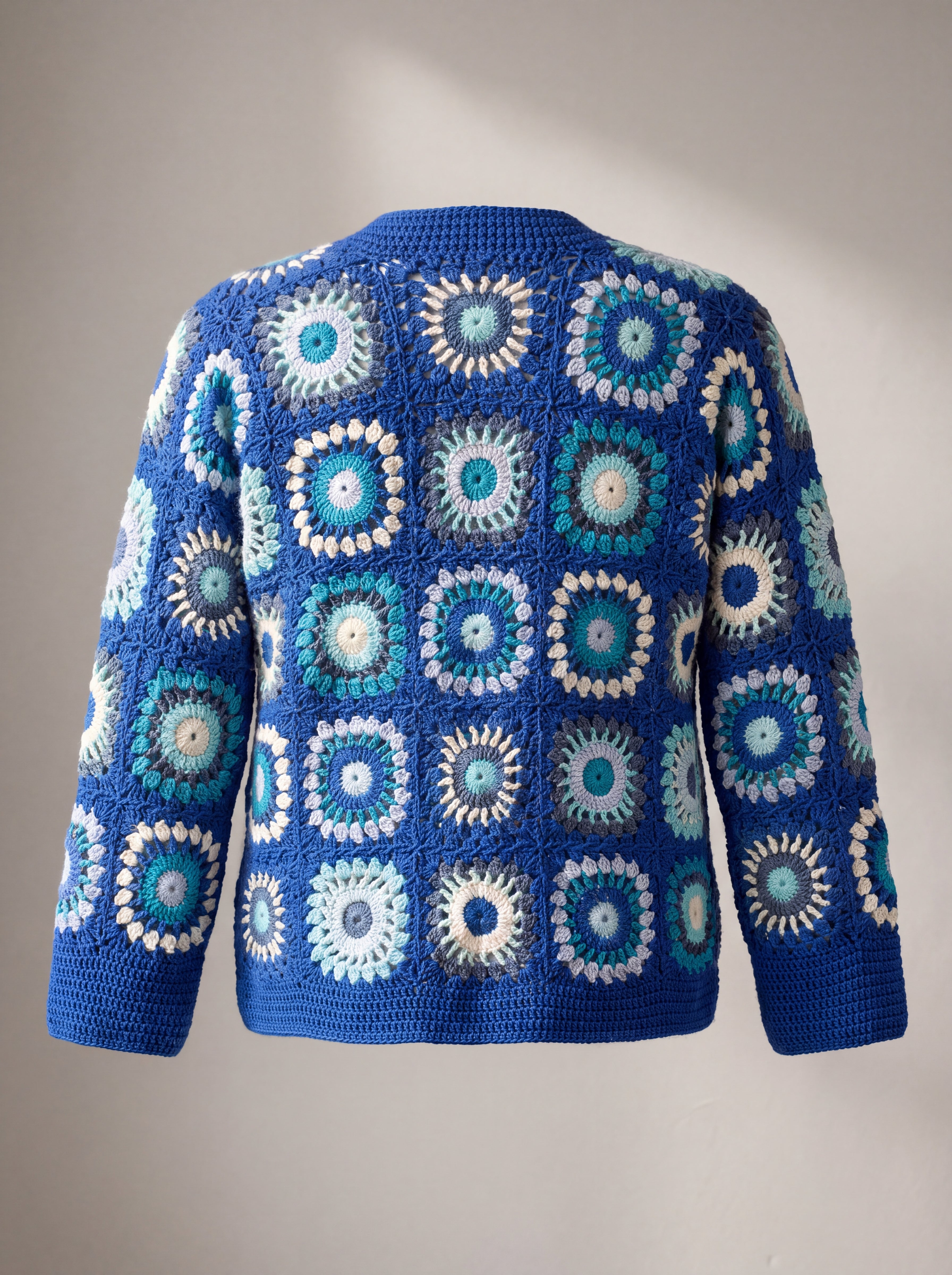 Back of the Mosaic Cardigan in cobalt and aqua, ringed puff-stitch squares in sea blues and cream on cobalt - handmade by Ana Chic