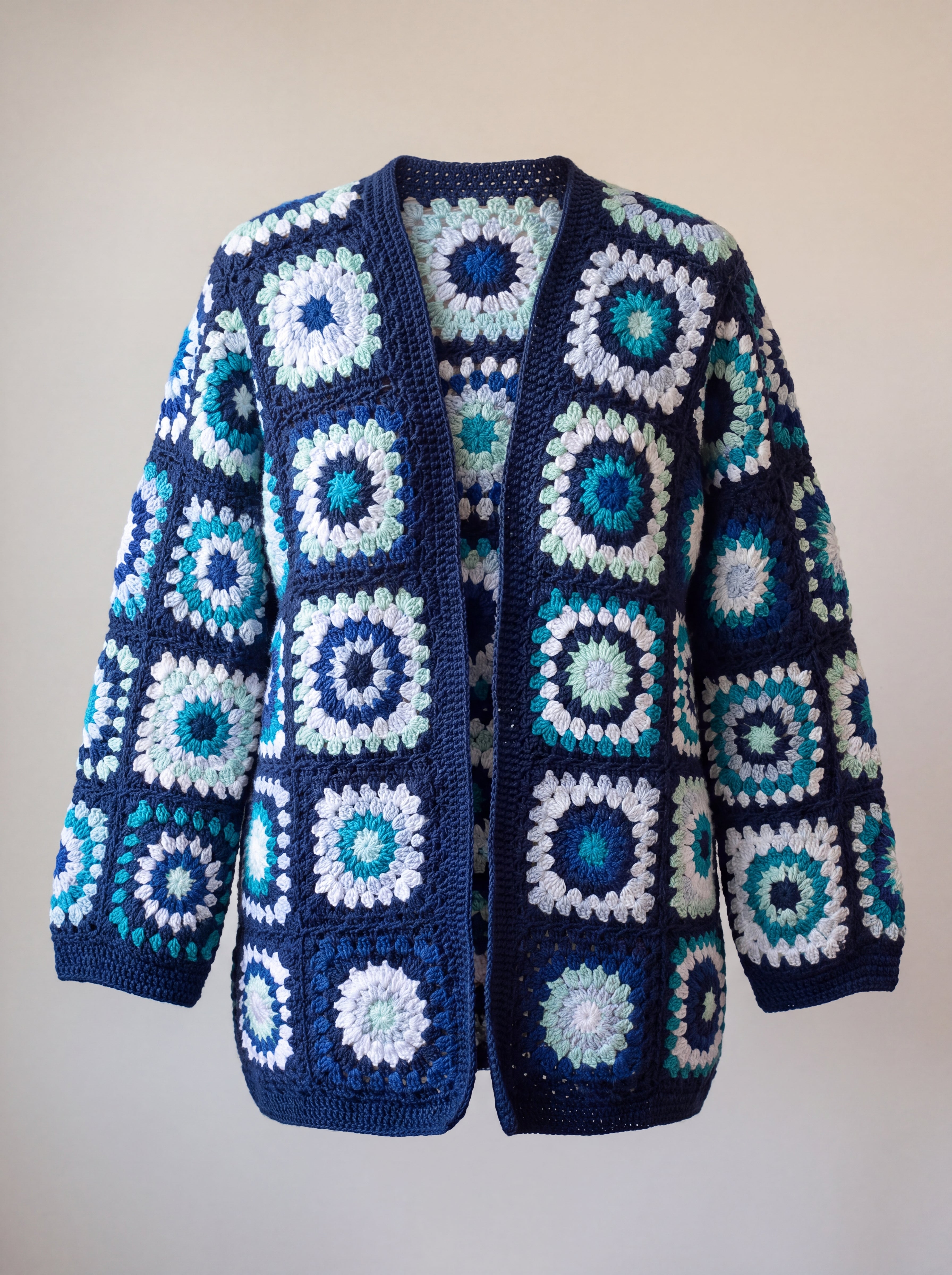Front of the Long Cardigan in navy and turquoise, ringed crocheted squares in turquoise, mint, ice blue and white on navy - handmade by Ana Chic