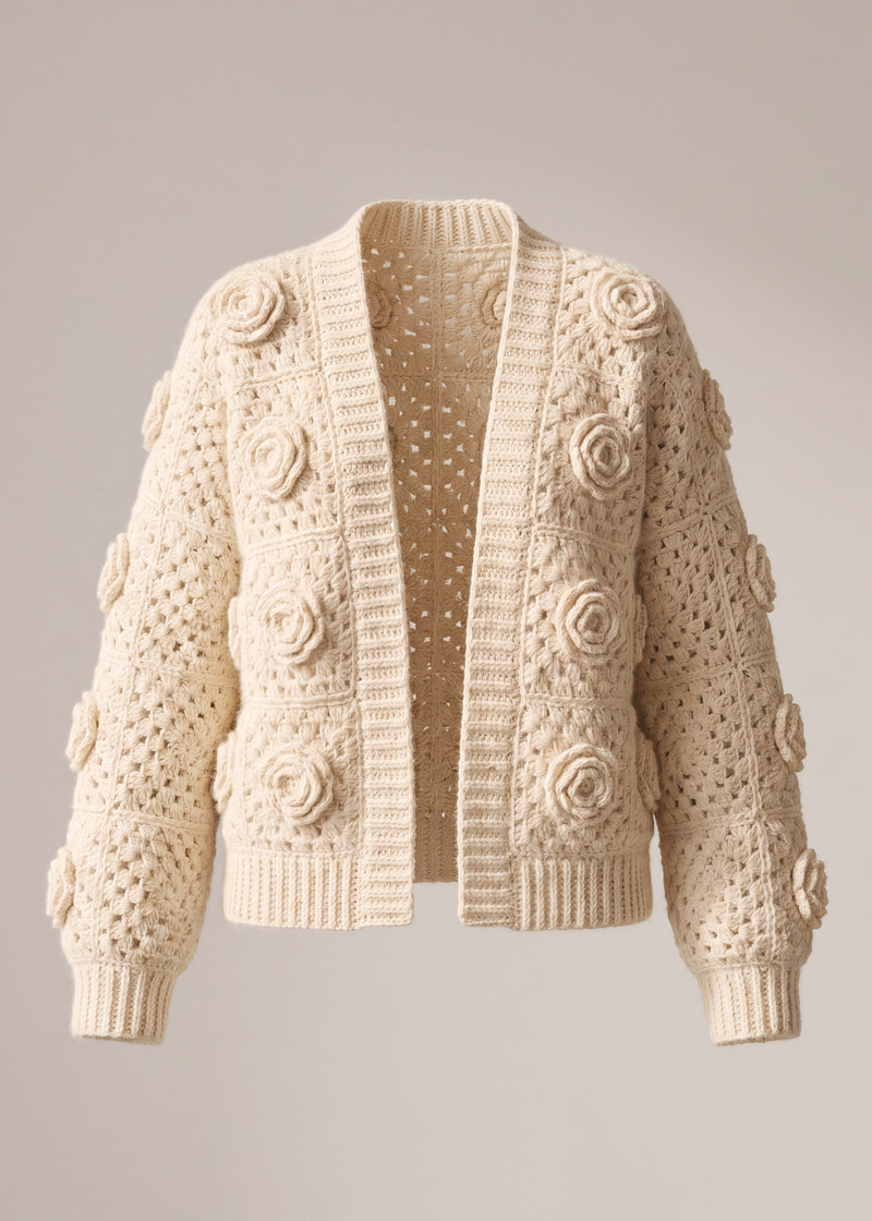 Ecru crochet cardigan with a raised rose on every square, open front, laid flat — handmade by Ana Chic