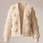 Ecru crochet cardigan with a raised rose on every square, open front, laid flat — handmade by Ana Chic