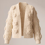 Ecru crochet cardigan with a raised rose on every square, open front, laid flat — handmade by Ana Chic