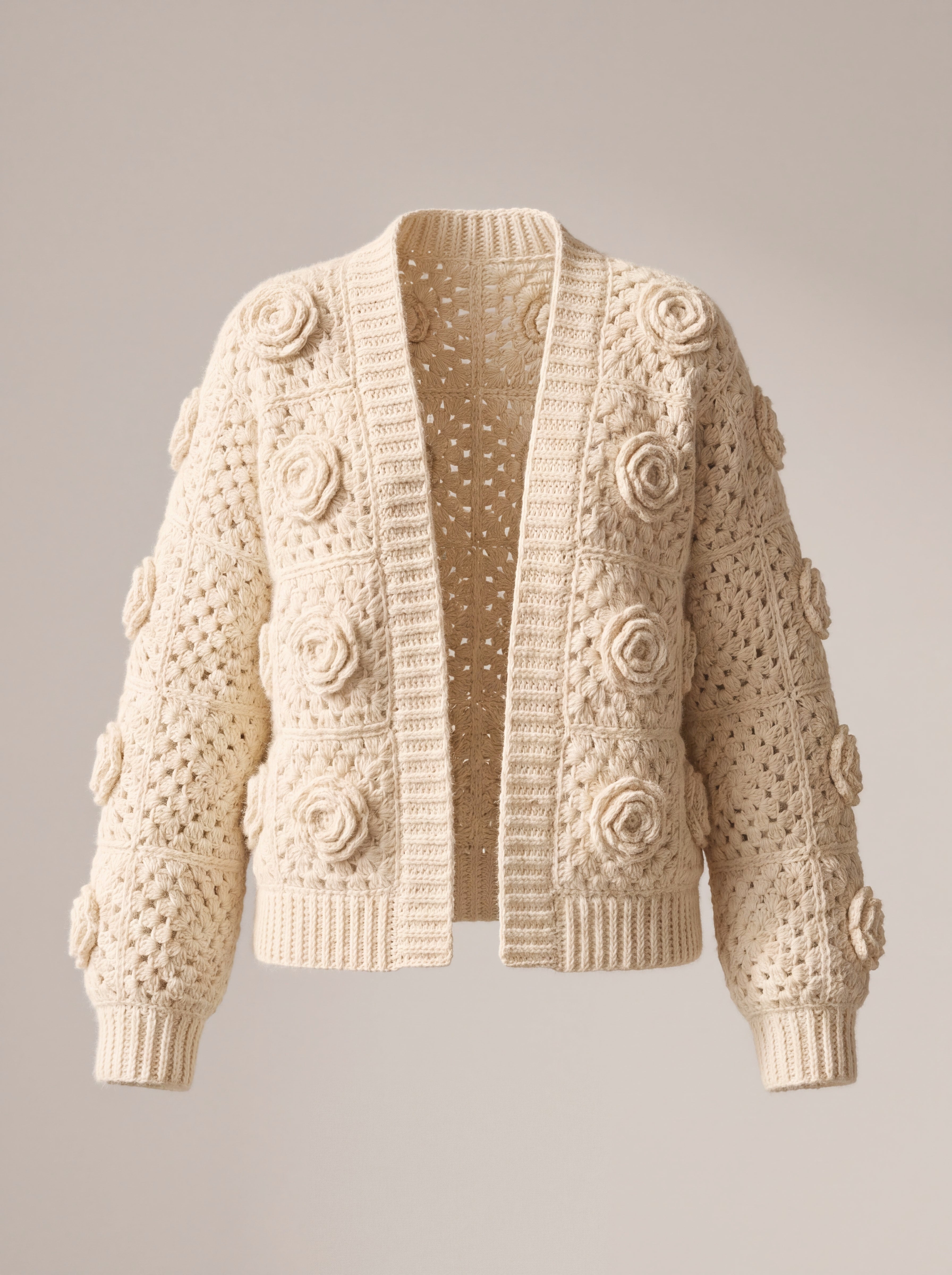 Ecru crochet cardigan with a raised rose on every square, open front, laid flat — handmade by Ana Chic