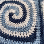 Macro of a hand-crocheted spiral square in navy, powder blue and white, Sampler Long Cardigan
