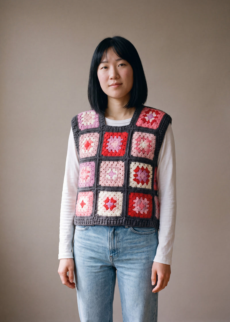 Rose granny square crochet vest worn over a white long-sleeve tee