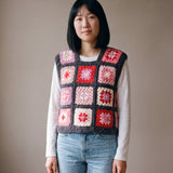 Rose granny square crochet vest worn over a white long-sleeve tee