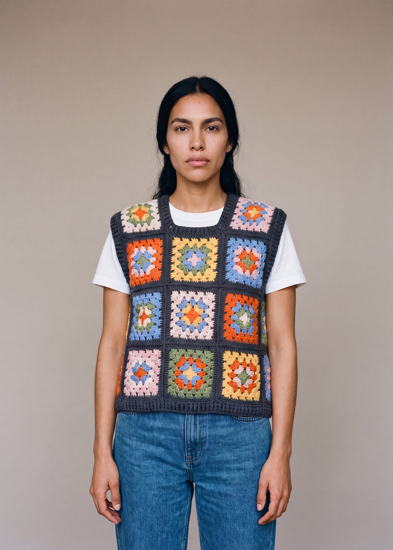 Multicolour granny square crochet vest worn over a white tee