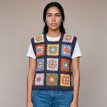Multicolour granny square crochet vest worn over a white tee