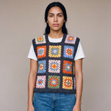 Multicolour granny square crochet vest worn over a white tee