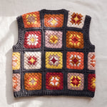 Terracotta granny square crochet vest, back, laid flat on linen