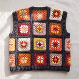 Terracotta granny square crochet vest, back, laid flat on linen