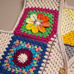 Close-up of the Pinwheel Vest: hand-crocheted squares, each one a different design