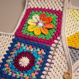 Close-up of the Pinwheel Vest: hand-crocheted squares, each one a different design