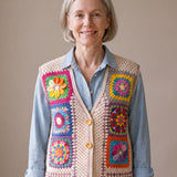 Woman wearing the Pinwheel Vest, a handmade granny square crochet vest, over a pale blue chambray shirt and light jeans