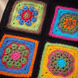 Close-up of the Electra Vest: hand-crocheted squares, each one a different design