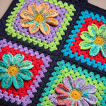 Close-up of the Moonflower Vest: hand-crocheted squares, each one a different design