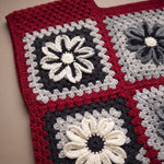 Close-up of the Cinder Vest: hand-crocheted squares, each one a different design